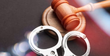 Judge’s gavel and handcuffs representing criminal defense in Plano